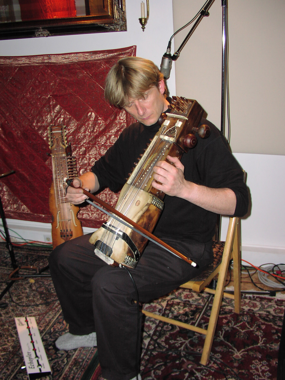 Hans Christian playing sarangi on Echoes with Rasa.